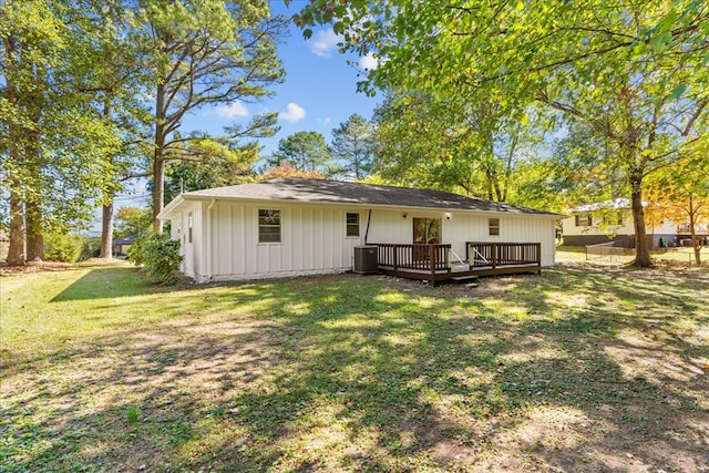 back of house featuring central AC unit, a yard, and a deck