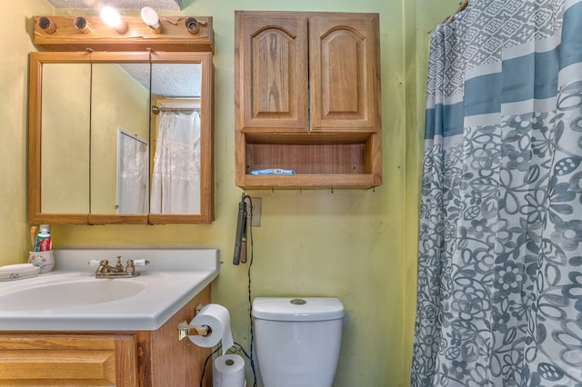 full bathroom with vanity, a shower with shower curtain, and toilet