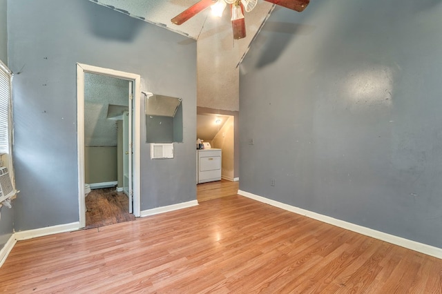 unfurnished bedroom with light wood-type flooring, washer / clothes dryer, a closet, baseboards, and ceiling fan