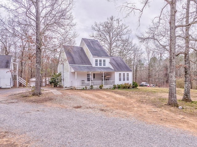 view of front of house with a porch, an outbuilding, and driveway