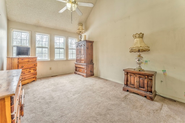 unfurnished bedroom with ceiling fan, baseboards, carpet floors, a textured ceiling, and high vaulted ceiling