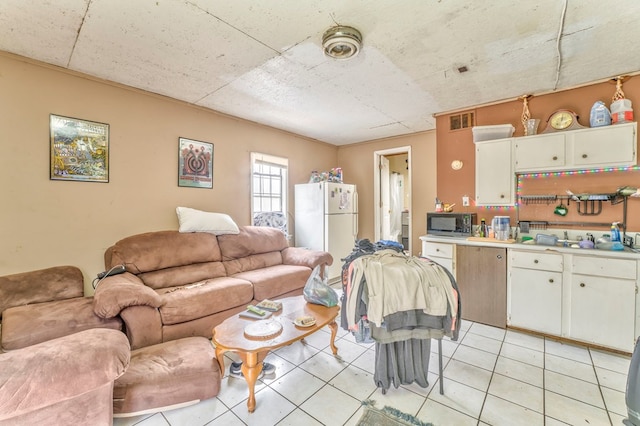 living room with light tile patterned floors and visible vents