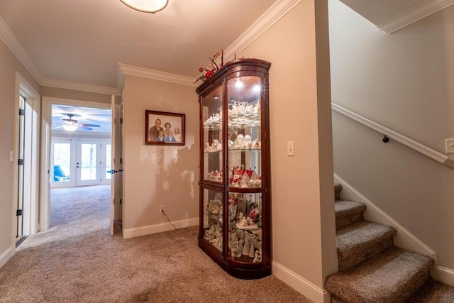 corridor featuring ornamental molding, french doors, and carpet flooring