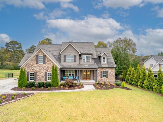 craftsman-style house featuring a front yard and covered porch