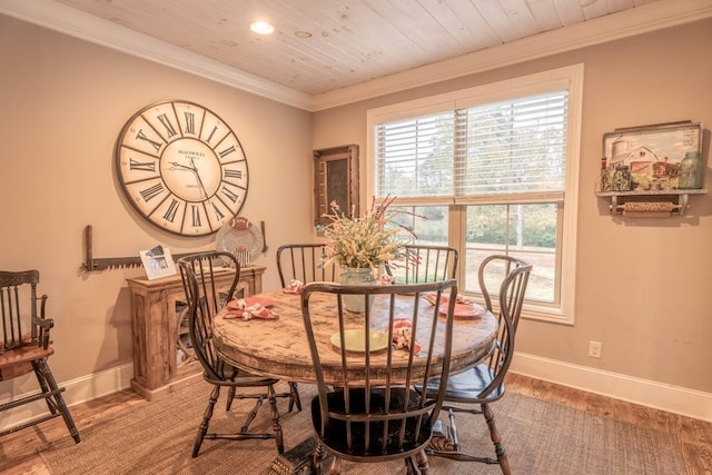 dining area with baseboards, crown molding, wood finished floors, and wooden ceiling