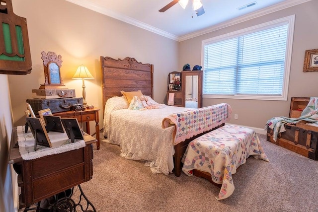 carpeted bedroom with ornamental molding and ceiling fan