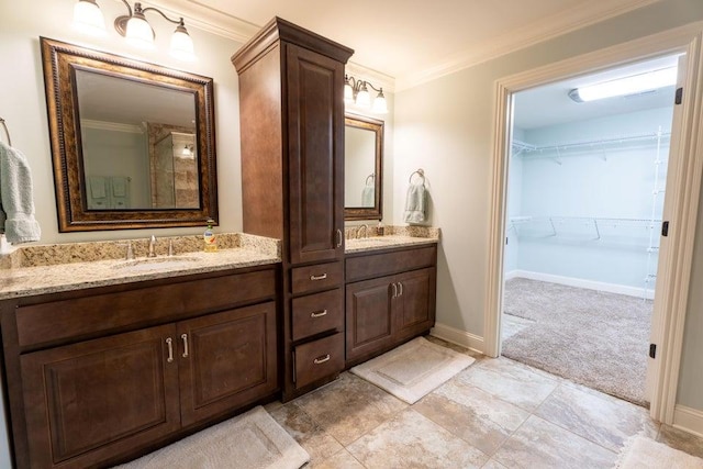 bathroom with double vanity, a sink, and ornamental molding