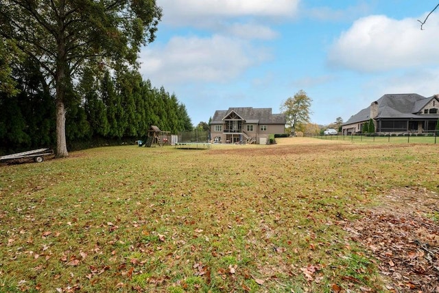 view of yard with a playground and a trampoline