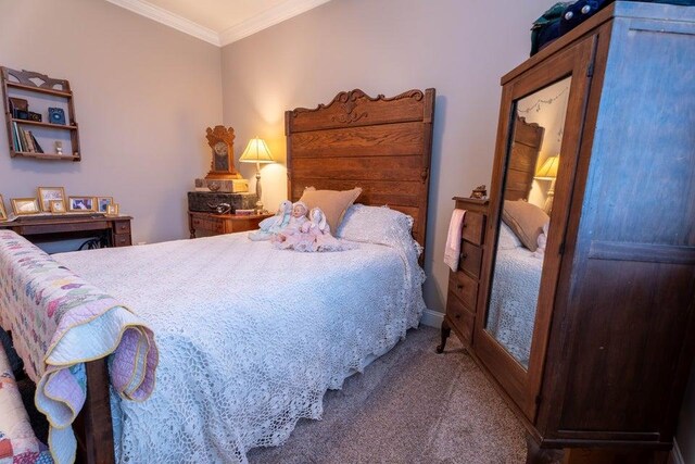 carpeted bedroom featuring ornamental molding