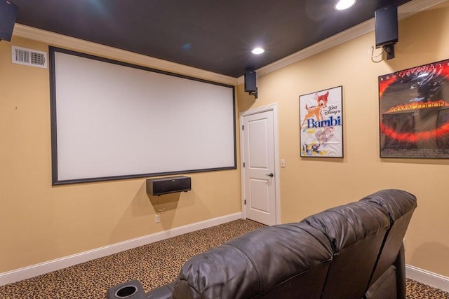 carpeted cinema room featuring baseboards, ornamental molding, visible vents, and recessed lighting