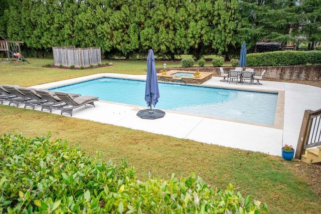 outdoor pool featuring a patio, a yard, and an in ground hot tub