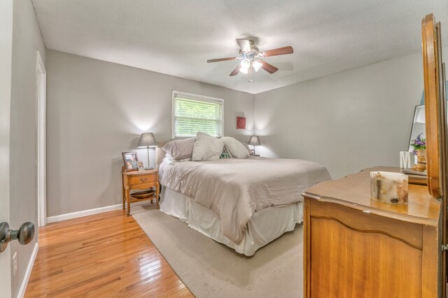 3012 Brookhaven Cir, Dalton, GA 30720 - bedroom featuring light wood-style floors, a ceiling fan, baseboards, and a textured ceiling