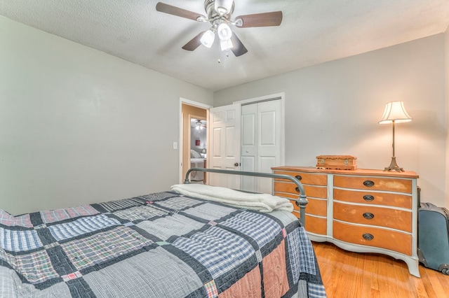 bedroom with a closet, light wood-style flooring, and ceiling fan