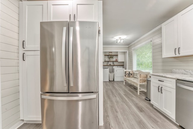 kitchen featuring separate washer and dryer, white cabinetry, appliances with stainless steel finishes, and light wood-type flooring