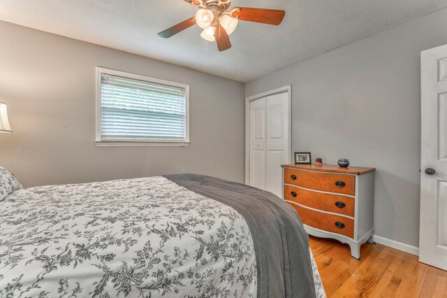 3012 Brookhaven Cir, Dalton, GA 30720 - bedroom featuring a closet, light wood-style floors, baseboards, ceiling fan, and a textured ceiling