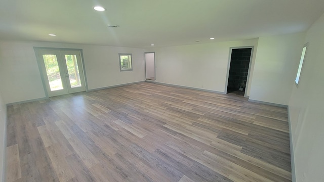 unfurnished room with light hardwood / wood-style floors and french doors