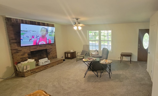 living room with ceiling fan, carpet floors, and a brick fireplace