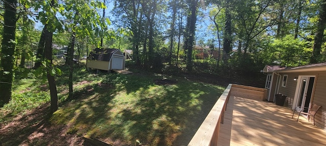 view of yard featuring a shed and a deck