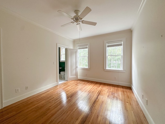 empty room with crown molding, light hardwood / wood-style flooring, and ceiling fan