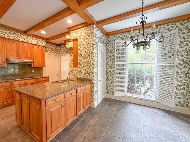 kitchen with sink, hanging light fixtures, black electric stovetop, a healthy amount of sunlight, and beam ceiling