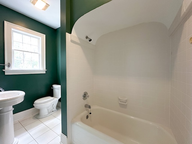 bathroom with toilet, bathing tub / shower combination, and tile patterned flooring