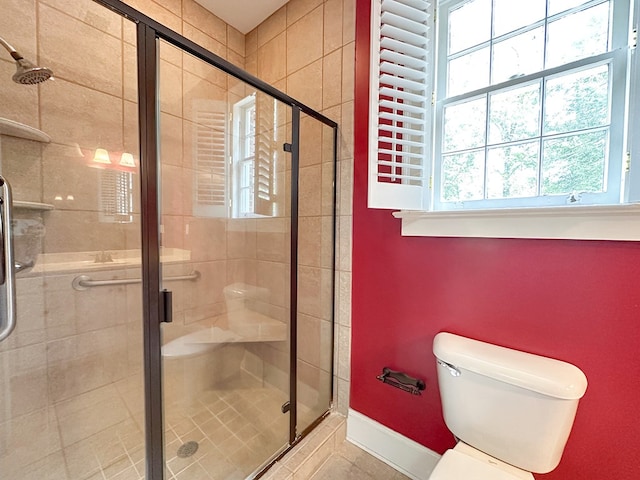 bathroom featuring an enclosed shower and toilet