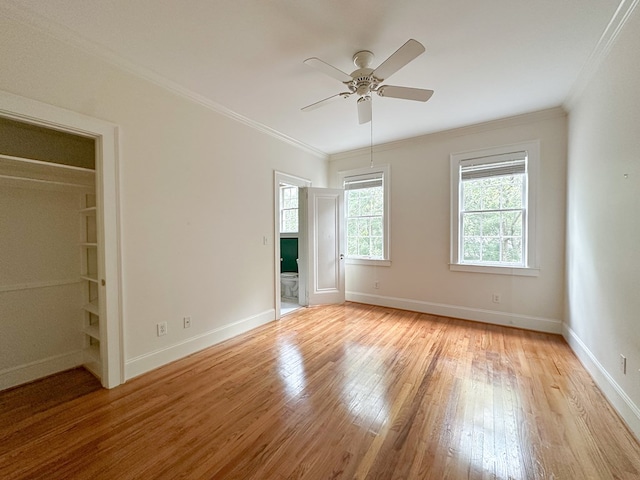 unfurnished bedroom with crown molding, ceiling fan, and light wood-type flooring