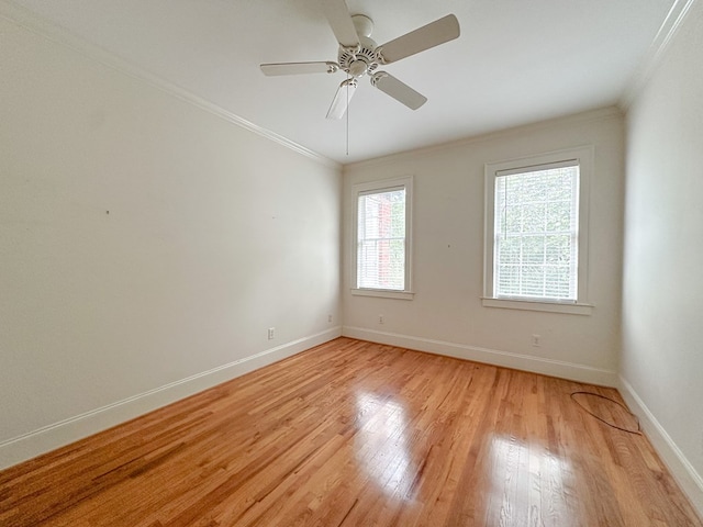 empty room featuring ornamental molding, ceiling fan, and light wood-type flooring