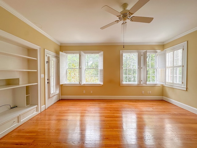 unfurnished sunroom with ceiling fan