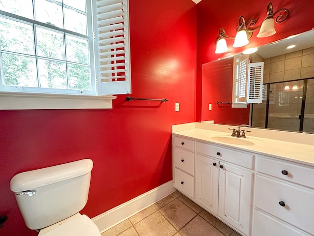 bathroom with vanity, a tile shower, tile patterned floors, and toilet