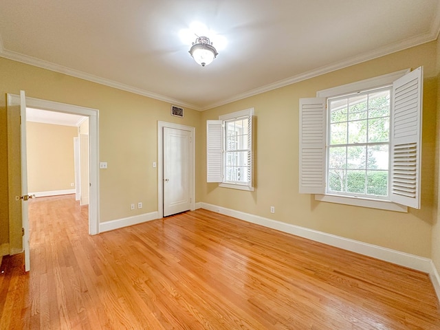 unfurnished bedroom with a closet, ornamental molding, and light hardwood / wood-style floors