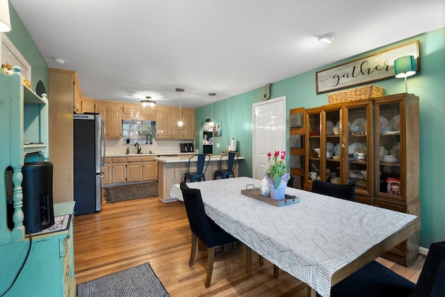 dining space featuring light wood finished floors