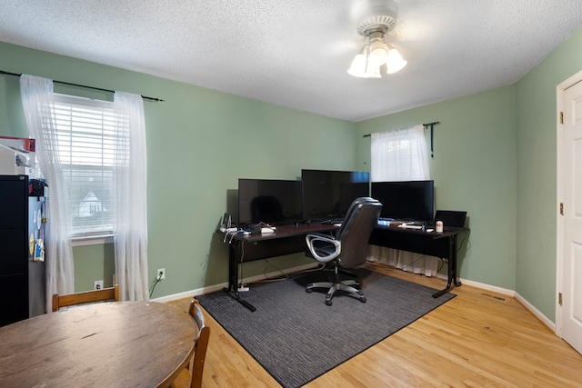 office area featuring a textured ceiling, wood finished floors, and baseboards