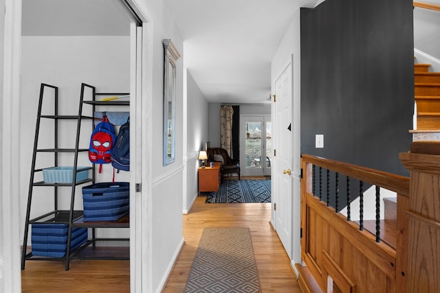 hall with stairway, baseboards, and wood finished floors