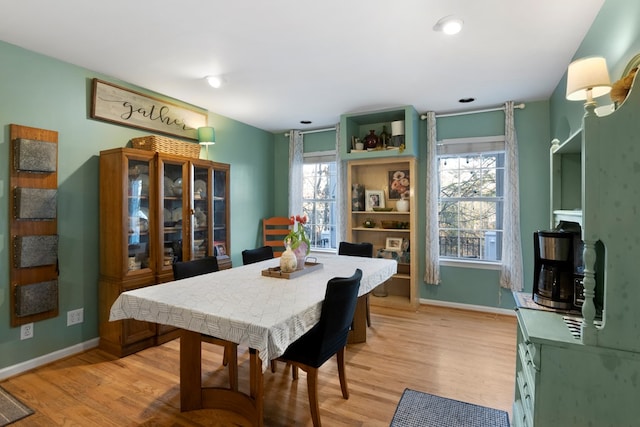 dining room with recessed lighting, baseboards, and light wood finished floors