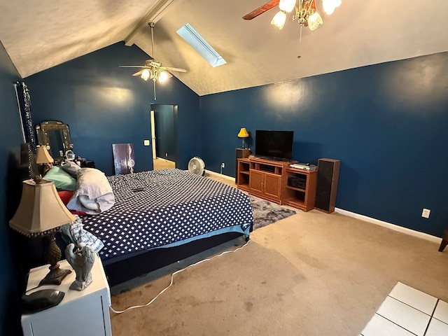 bedroom featuring ceiling fan, light colored carpet, and vaulted ceiling with skylight