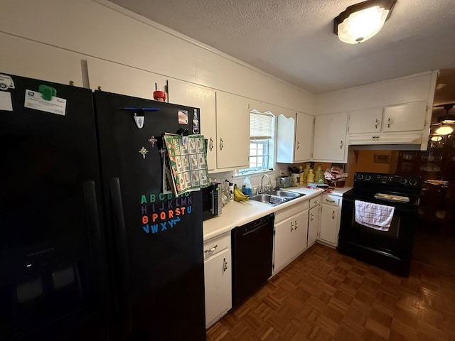 kitchen featuring dark parquet flooring, sink, black appliances, a textured ceiling, and white cabinets