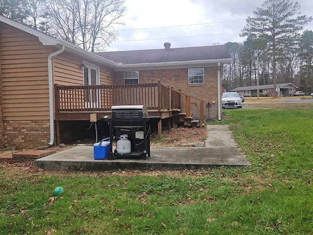 rear view of property featuring a yard and a deck