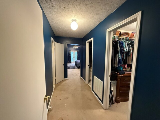 corridor featuring a textured ceiling