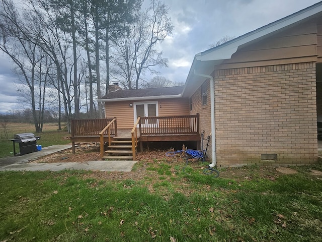 rear view of house featuring a wooden deck and french doors