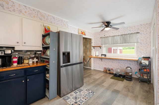 4223 Spring Valley Dr, Cohutta, GA 30710 - kitchen with wallpapered walls, stainless steel fridge, light wood-style floors, ceiling fan, and blue cabinetry