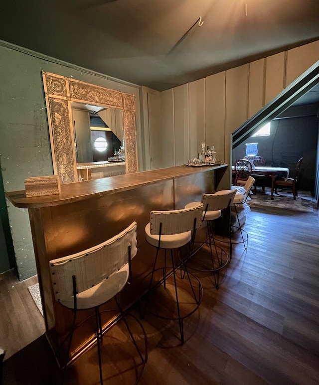 bar with dark hardwood / wood-style flooring