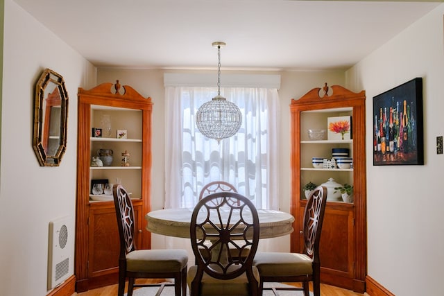 702 Lumpkin St, Dalton, GA 30720 - dining room featuring a chandelier, light wood-style floors, and heating unit