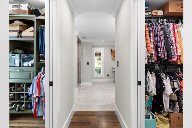 walk in closet with hardwood / wood-style floors