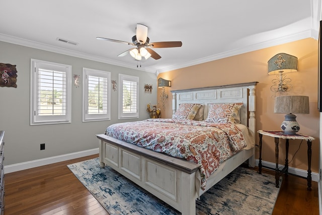 bedroom with dark wood-type flooring, ornamental molding, and ceiling fan