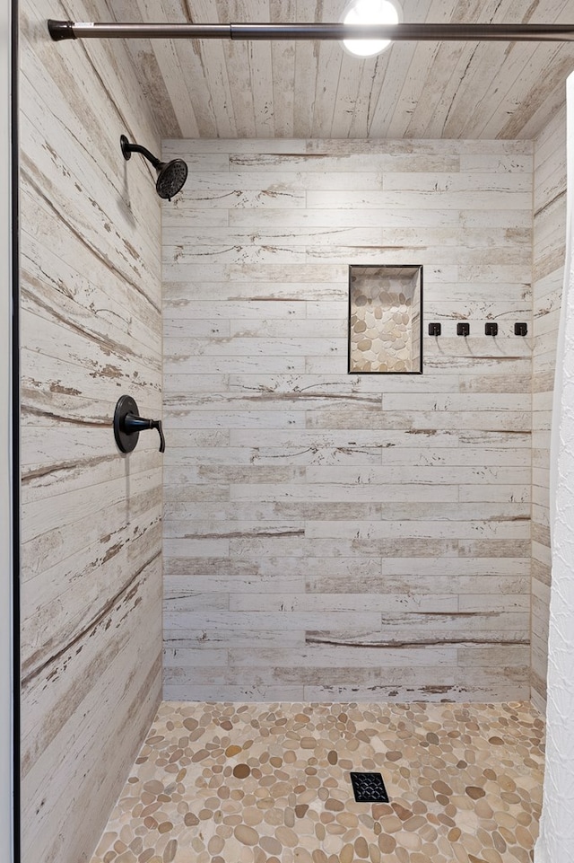 bathroom with wooden ceiling, wood walls, and walk in shower