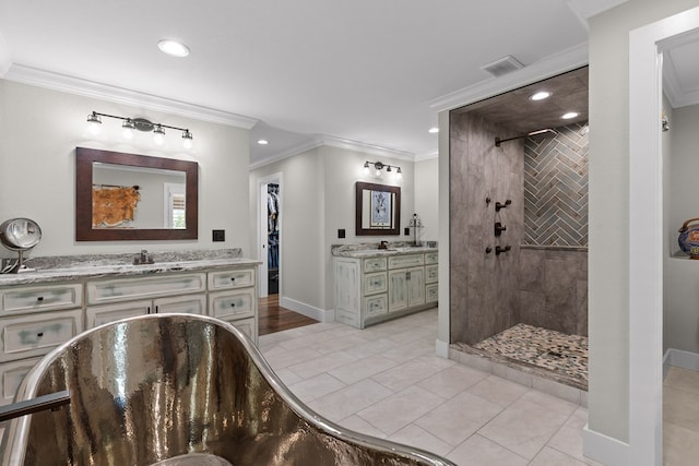 bathroom featuring vanity, crown molding, tile patterned floors, and tiled shower