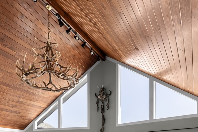 details featuring rail lighting and wooden ceiling