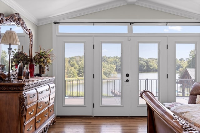 entryway with vaulted ceiling, ornamental molding, a water view, and dark hardwood / wood-style floors