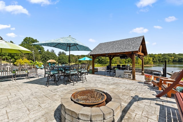 view of patio / terrace featuring a gazebo, an outdoor fire pit, and a water view